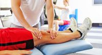 A therapist performing massage therapy on a patient
